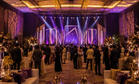 A wireframe globe sculpture stands in a purple-lit lobby with India: The Emerging Third Superpower branding.